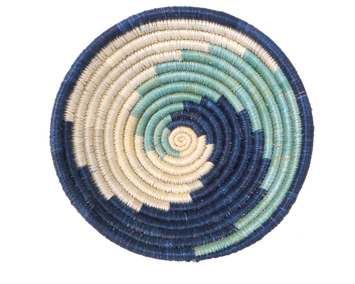 Round woven coaster with concentric circle pattern in blue, green, and beige on a white background
