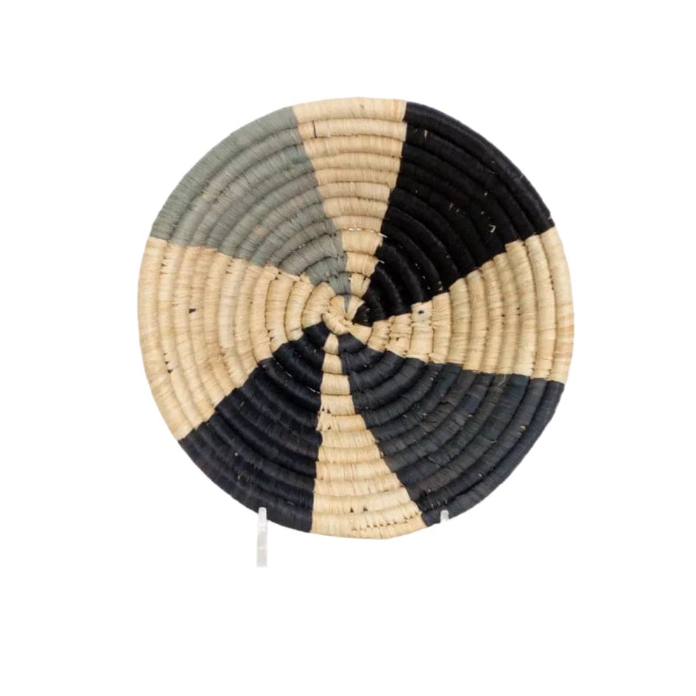 Round woven basket with black, beige, and gray color pattern on a white background