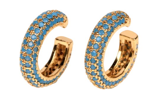 Gold hoop earrings with blue gemstones on a white background