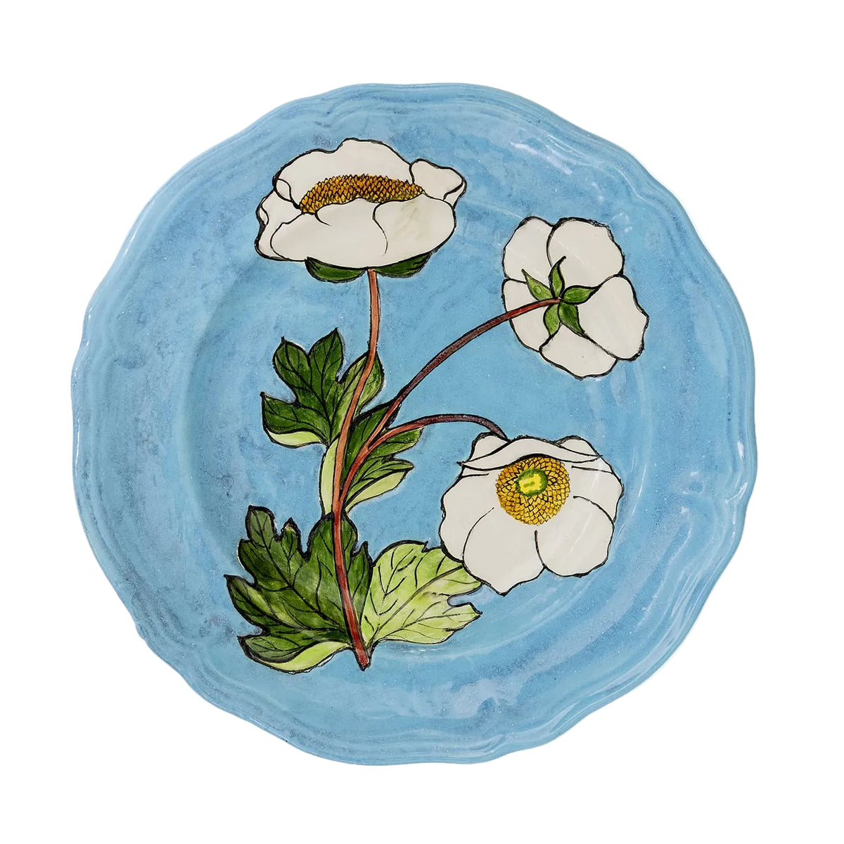 A round blue ceramic plate featuring a painted botanical design of three white flowers with yellow centers and green leaves, shown against a plain white background.