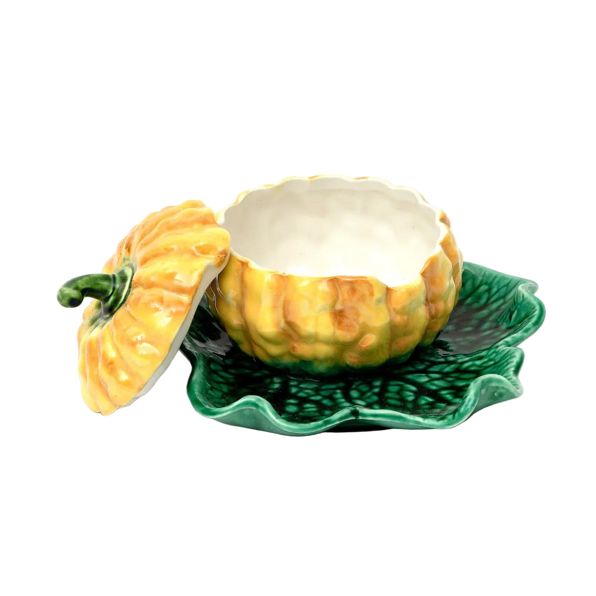 Decorative ceramic piece of a squash on a leaf-shaped plate with a white background
