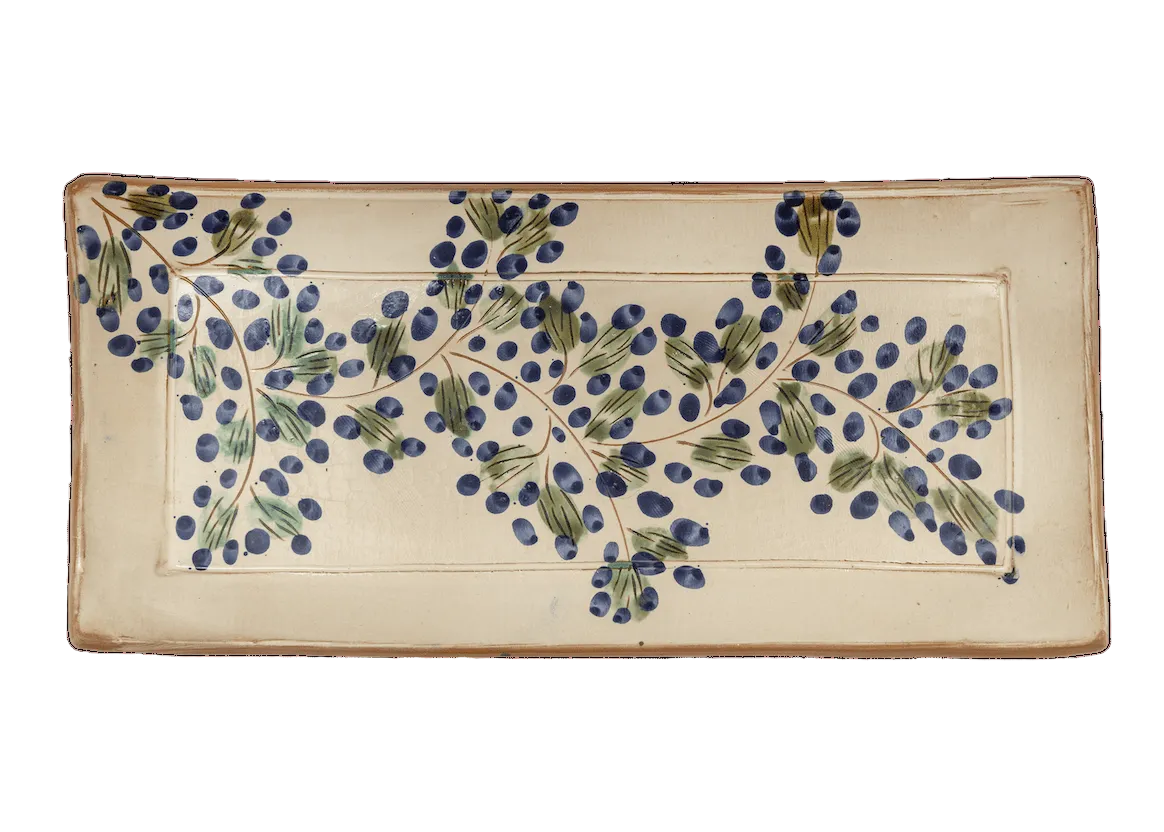 Decorative ceramic tile with blue floral design on a beige background