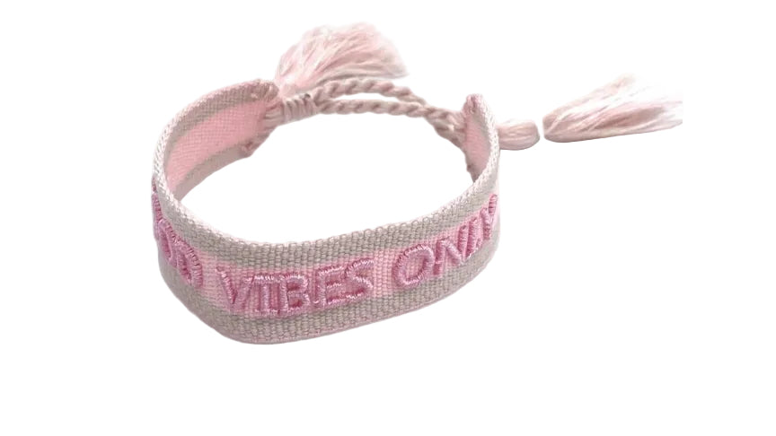 Pink bracelet with 'Vibes On' text on a pink background