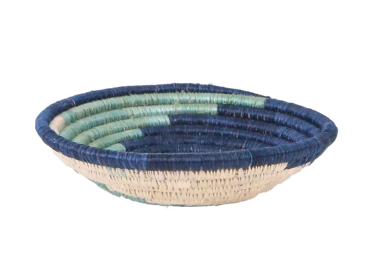 Woven bowl with blue and green pattern on a white background