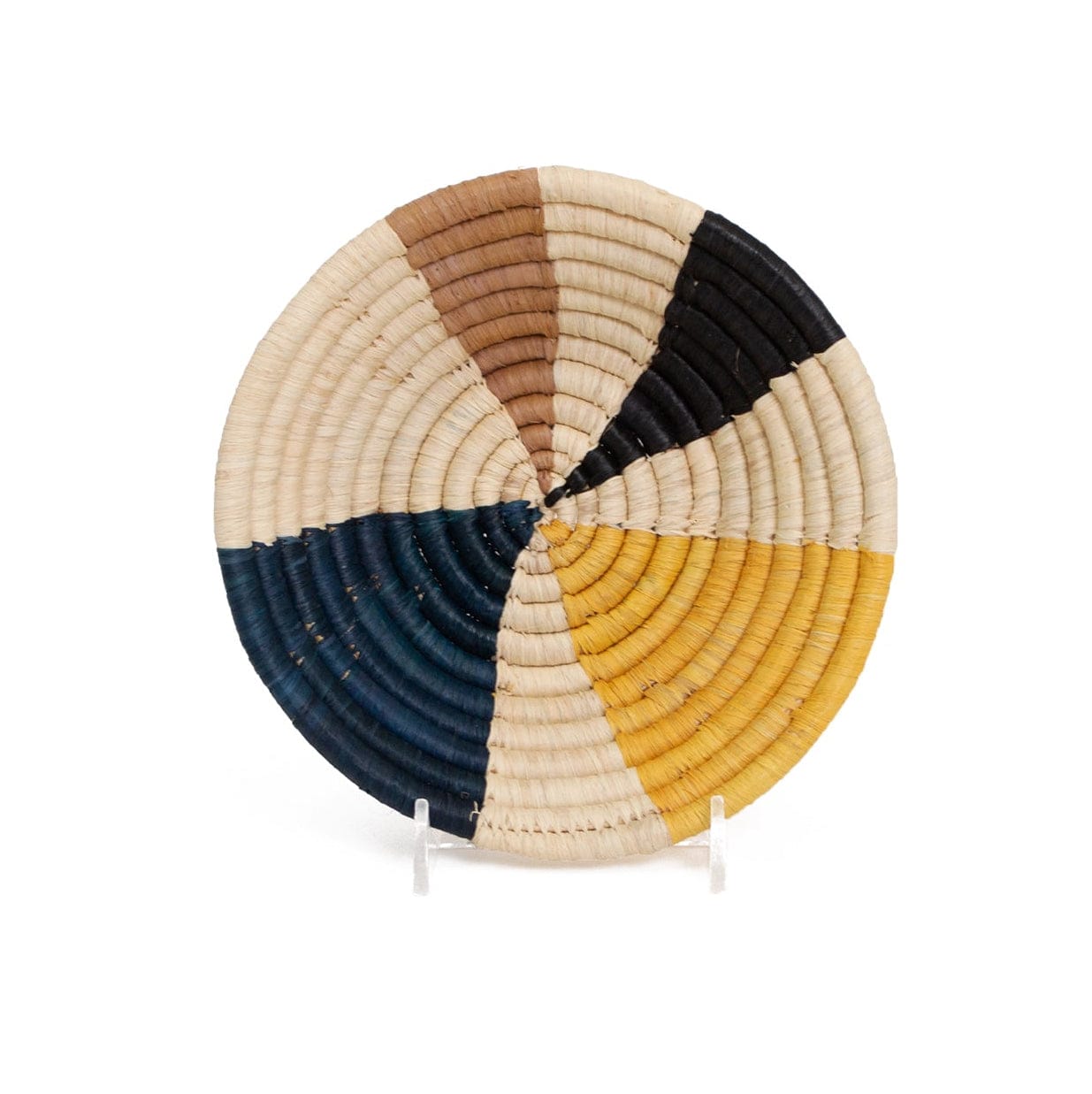 Round woven basket with multicolored design on a white background
