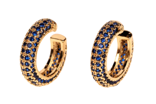 Gold hoop earrings with blue gemstones on a white background