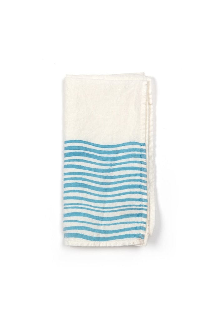 Folded towel with blue wave pattern on a white background