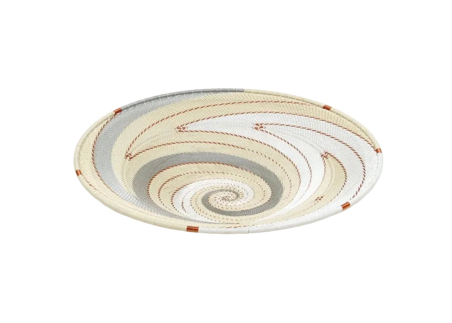 A handwoven open basket-shaped plate with ivory and beige color patterns, likely made from telephone wire, with a metal core.