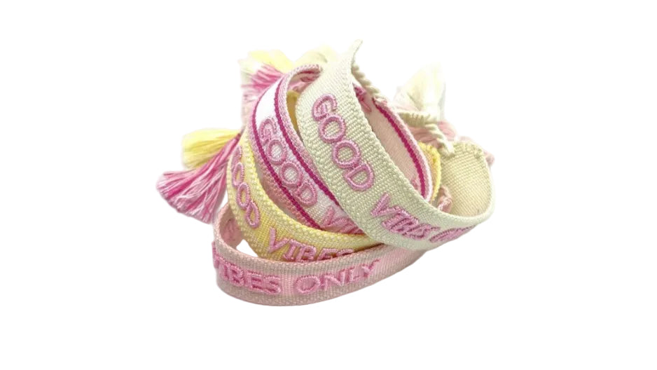 Two pink and yellow bracelets with 'Good Vibes Only' text on a white background