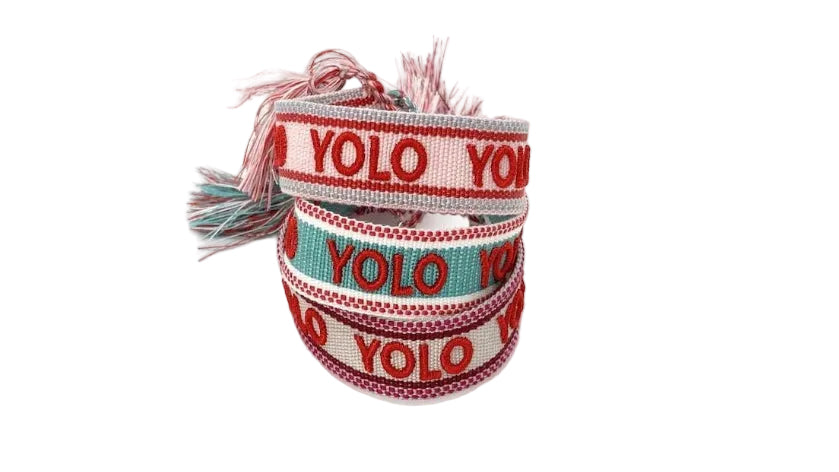 A set of colorful woven cotton friendship bracelets with the text 'YOLO' printed on them in red lettering against a white and blue background.