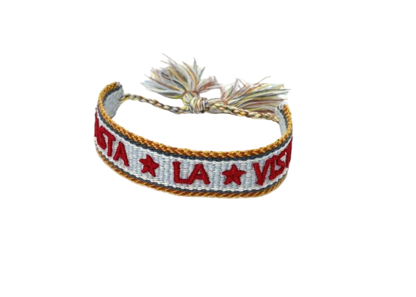 Bracelet with text and star design on a pale blue  background