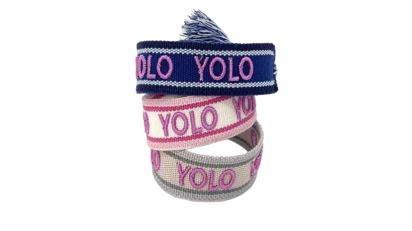 Three colorful bracelets with 'YOLO' text on a white background
